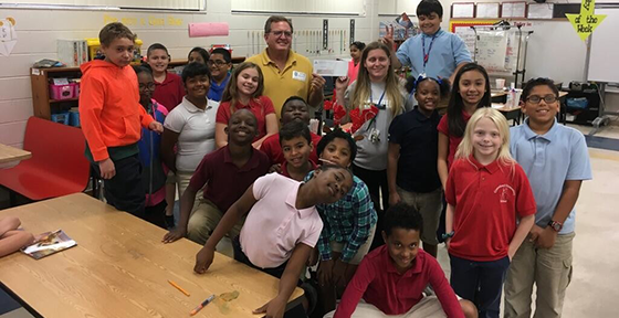 Director Dan Olson awards a Mini-Grant to Kayla Coxe at Groveland Elementary School.